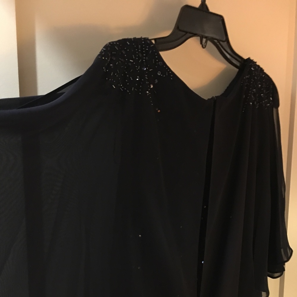 Dark blue gown. Sequence shoulder, peek-a-boo sleeve.